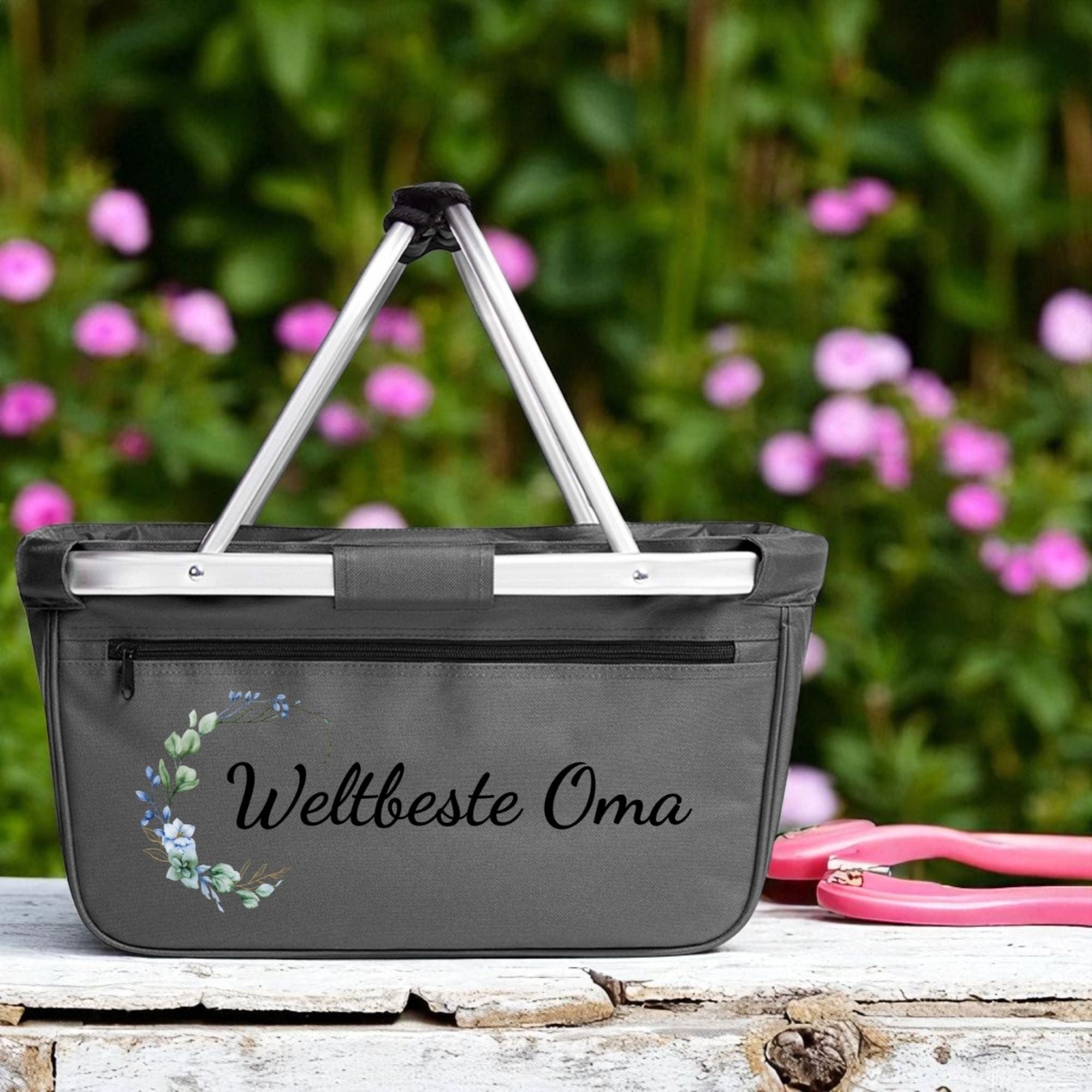 Einkaufskorb „Weltbeste Oma“ mit Eukalyptus-Blumendesign auf Holztisch im Garten